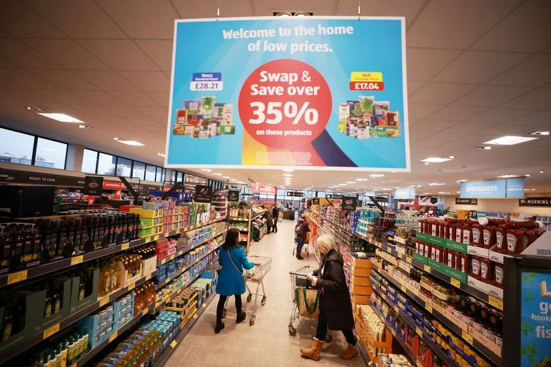 Labeled Aldi Super 6 fresh fruit and vegetable display in a UK retail store.