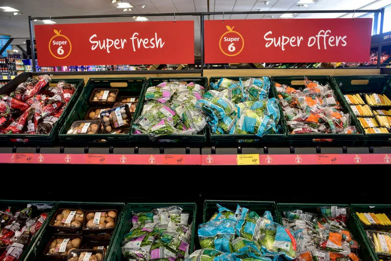 Labeled Aldi Super 6 fresh fruit and vegetable display in a UK retail store.