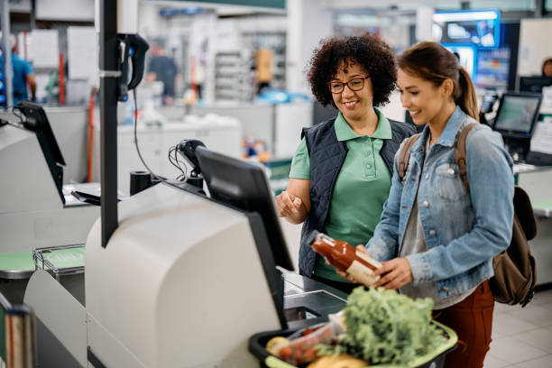 Why UK Food Prices Continue to Change: The Crucial 2026 Structural Shift Close-up of a shopper counting British pound coins at a supermarket self-checkout kiosk. Why UK Food Prices Continue to Change
