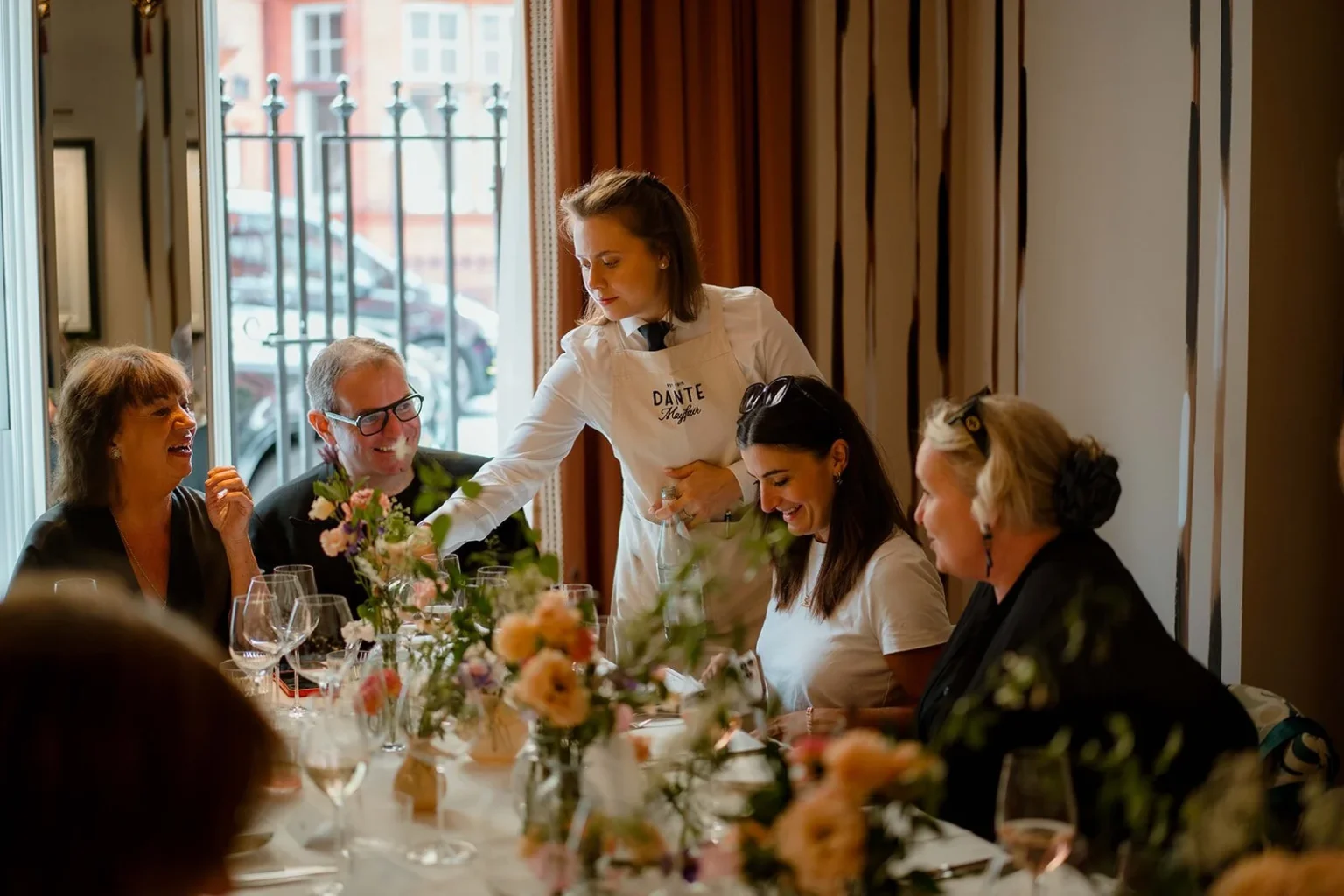 Restaurant manager and head chef inspecting digital employee rota software inside a London dining room. UK hospitality employment update 2026