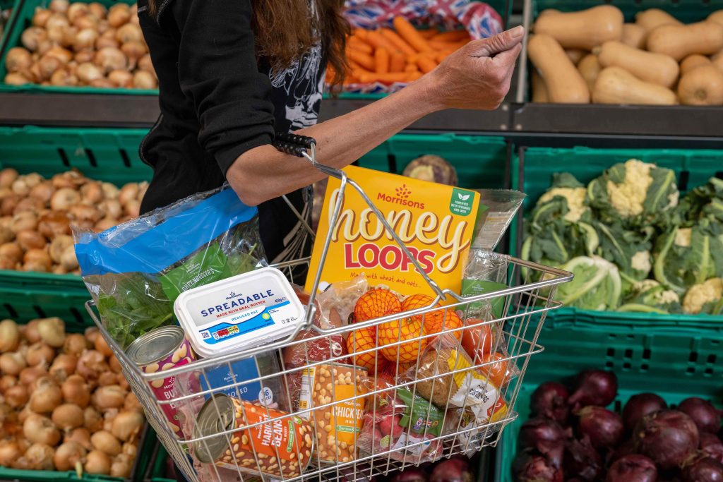 Packaged supermarket foods alongside fresh vegetables for an explanation of ultra-processed foods